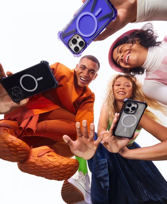 three people happy- phones-looking down to camera