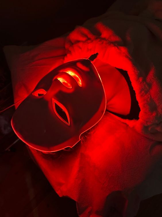 red-led face mask- above angle- woman wearing it