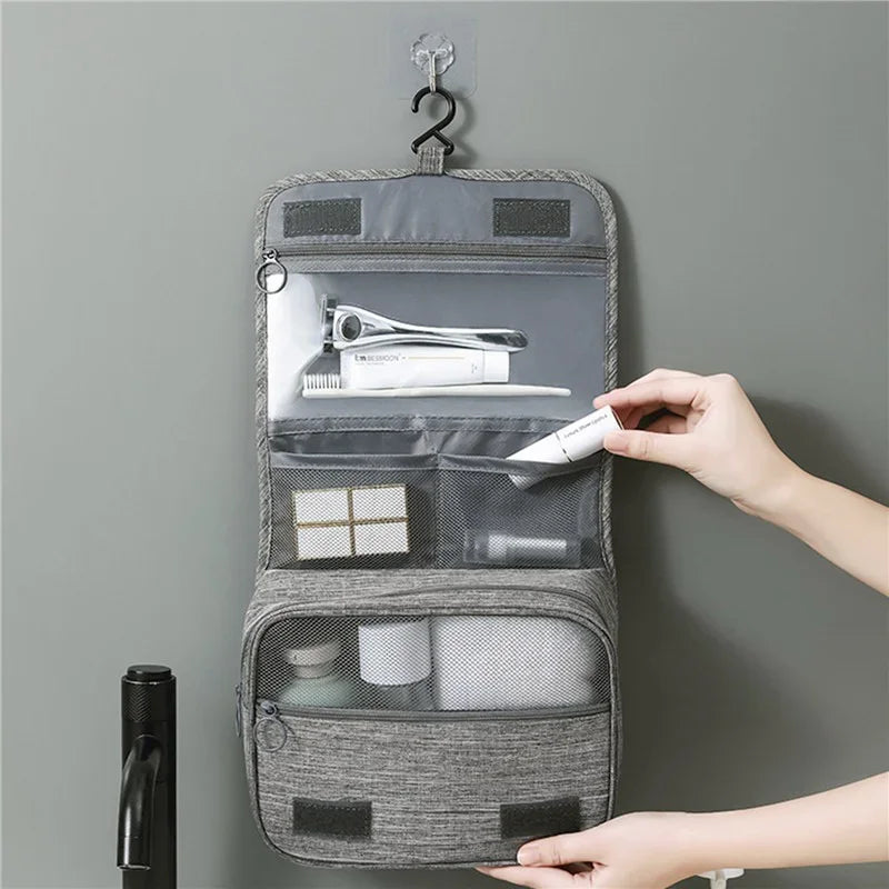 grey- hanging toiletry bag- unfolded- pockets- skincare products- front angle